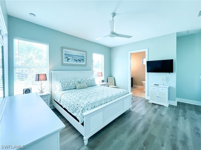 bedroom featuring dark hardwood / wood-style floors, ceiling fan, and connected bathroom