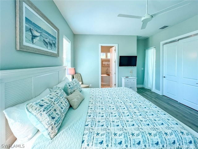 bedroom with a closet, dark wood-type flooring, connected bathroom, and ceiling fan