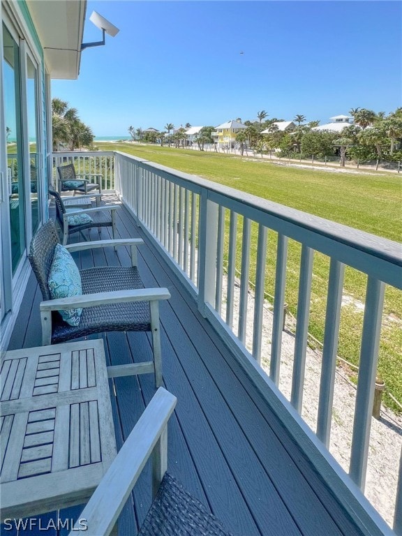 wooden deck with a lawn