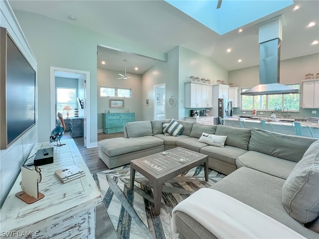 living room with high vaulted ceiling and ceiling fan