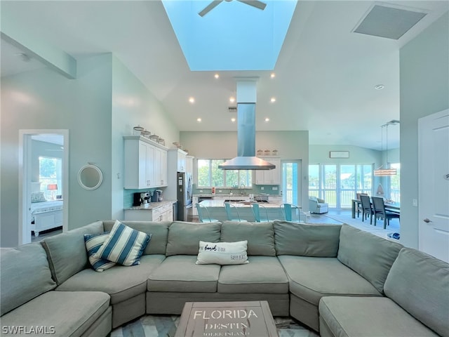 living room featuring high vaulted ceiling, ceiling fan, and sink