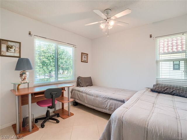 tiled bedroom featuring ceiling fan