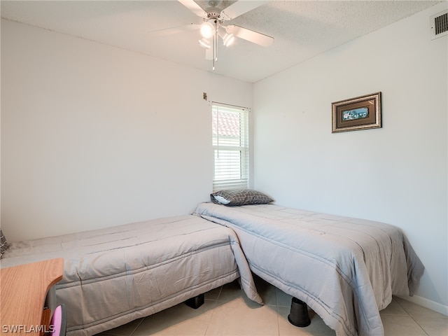 bedroom with tile floors and ceiling fan