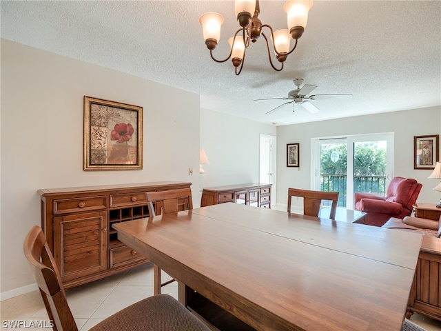 dining area featuring ceiling fan with notable chandelier, light tile floors, and a textured ceiling