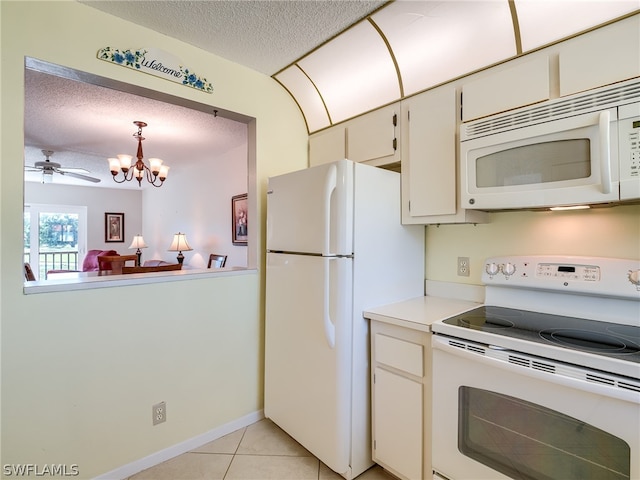 kitchen featuring light tile floors, a textured ceiling, white appliances, ceiling fan with notable chandelier, and hanging light fixtures