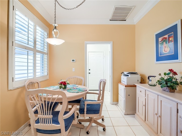 dining room featuring crown molding and light tile floors