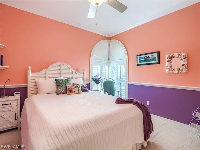 carpeted bedroom with ornamental molding and ceiling fan