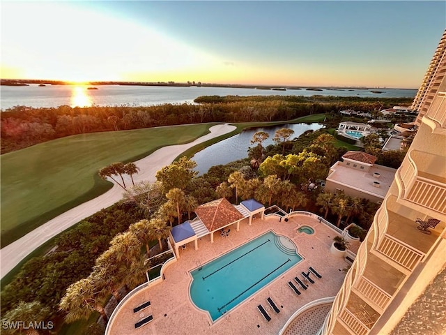 aerial view at dusk featuring a water view