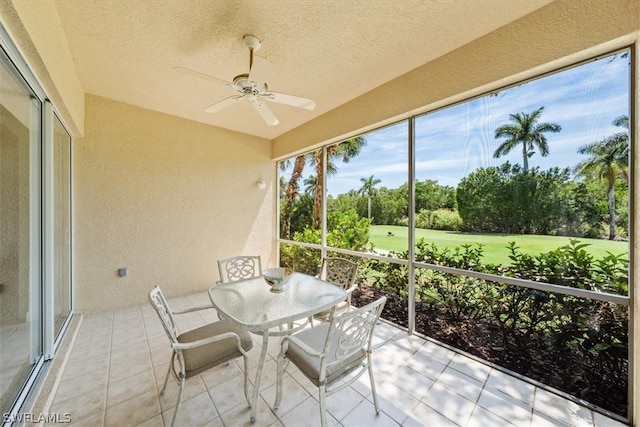 sunroom featuring ceiling fan