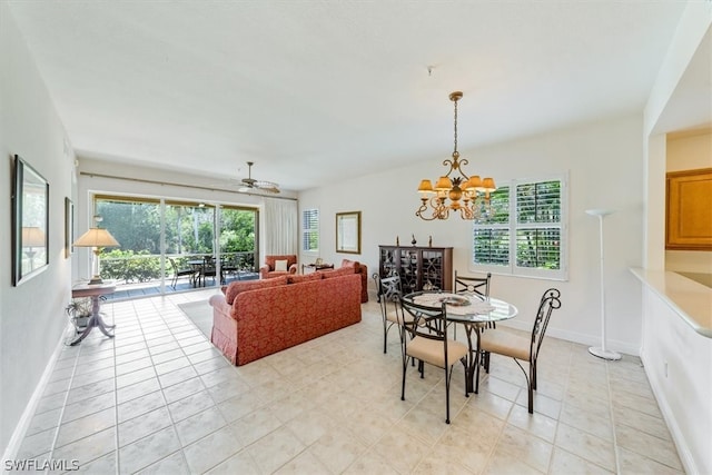 dining space featuring ceiling fan with notable chandelier and light tile floors