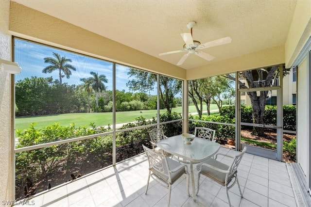 unfurnished sunroom with a healthy amount of sunlight and ceiling fan