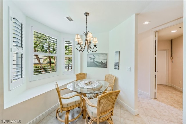 dining area featuring an inviting chandelier and light tile flooring