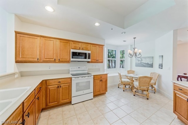 kitchen featuring hanging light fixtures, white appliances, light tile flooring, sink, and a notable chandelier