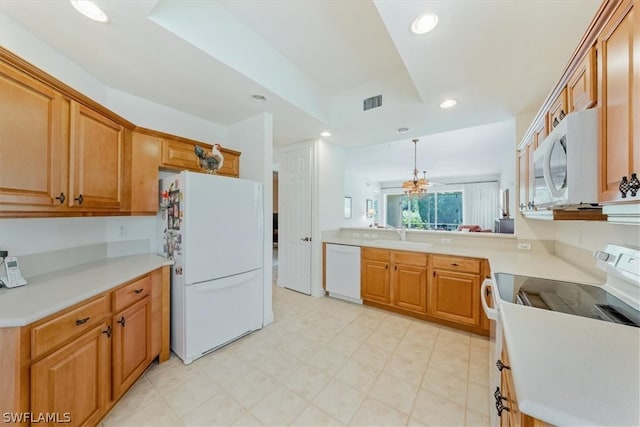 kitchen with sink, white appliances, light tile flooring, and kitchen peninsula