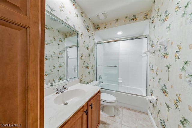 full bathroom with vanity with extensive cabinet space, toilet, tile flooring, and combined bath / shower with glass door