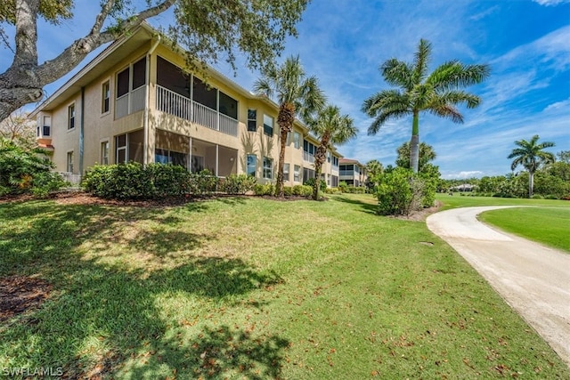 view of property's community with a lawn