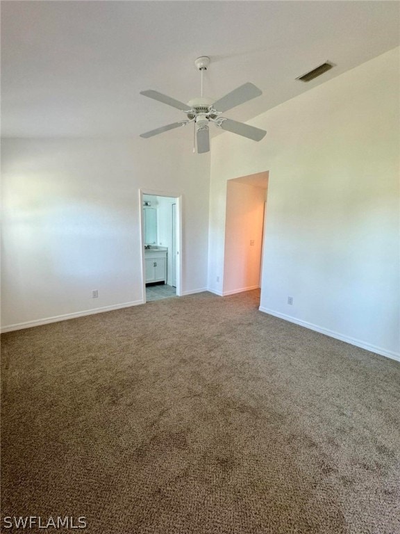 empty room featuring high vaulted ceiling, ceiling fan, and carpet flooring