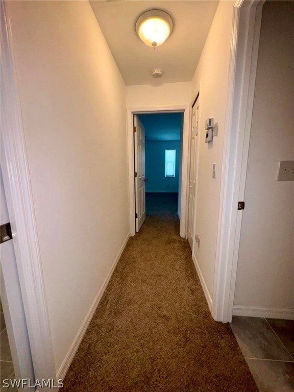 corridor with dark tile floors