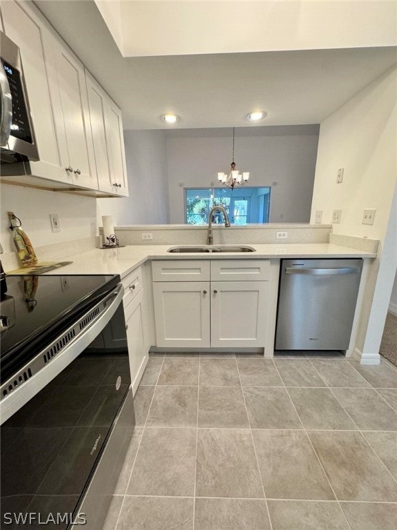 kitchen featuring sink, appliances with stainless steel finishes, white cabinetry, and light tile floors