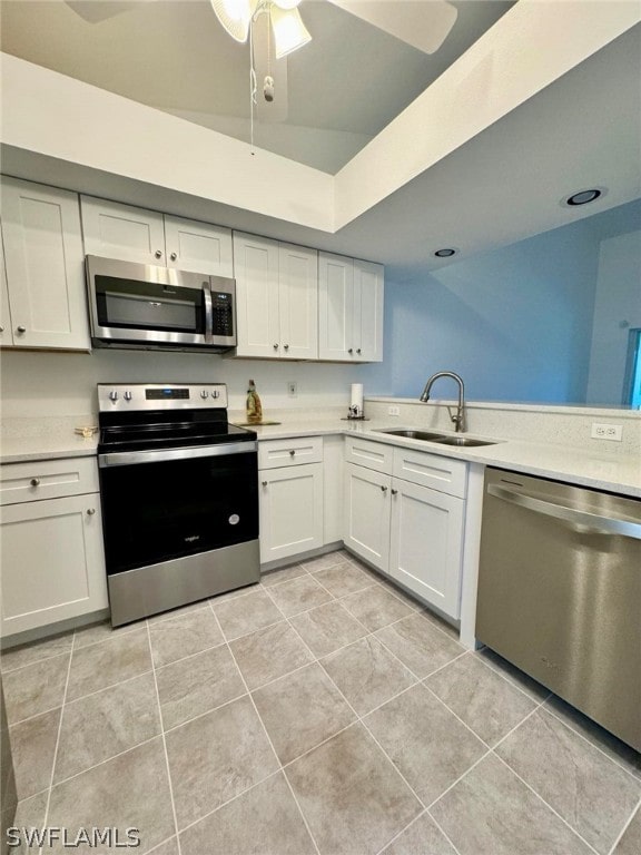 kitchen with white cabinetry, appliances with stainless steel finishes, ceiling fan, and light tile floors