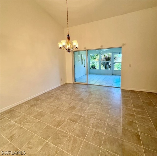 empty room with high vaulted ceiling, a notable chandelier, french doors, and light tile flooring