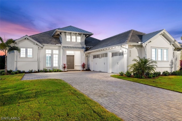 view of front facade featuring a garage and a yard