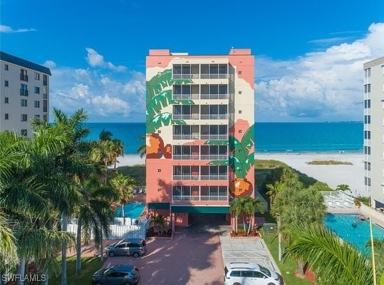 view of property with a beach view and a water view