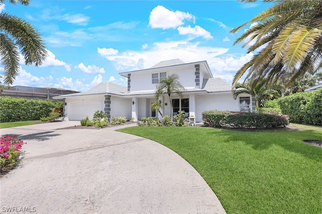 view of front of property with a front lawn and a garage