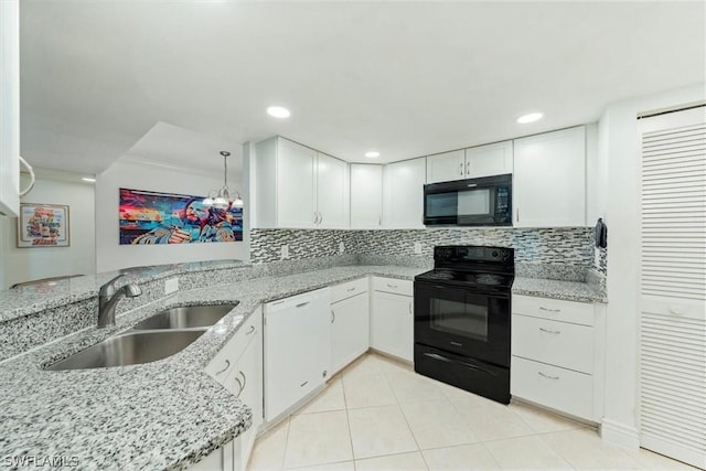 kitchen featuring decorative backsplash, light stone counters, sink, black appliances, and white cabinets