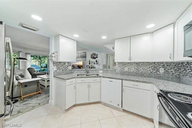 3180 Seasons Way Unit 908, Estero, FL 33928 - kitchen with white dishwasher, a sink, white cabinets, electric range oven, and backsplash