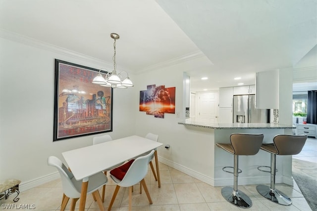 dining space featuring a notable chandelier, light tile patterned flooring, and crown molding