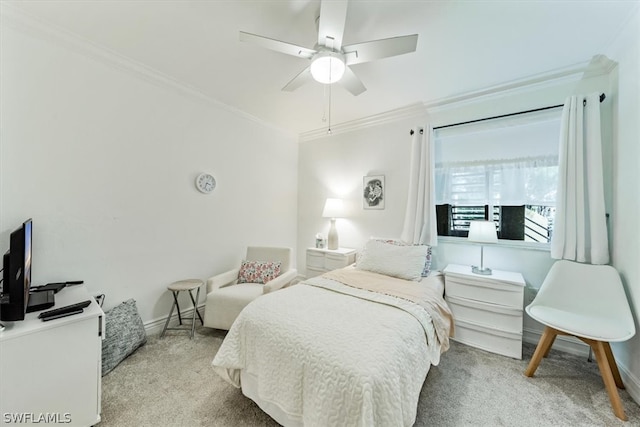 carpeted bedroom featuring ceiling fan and ornamental molding