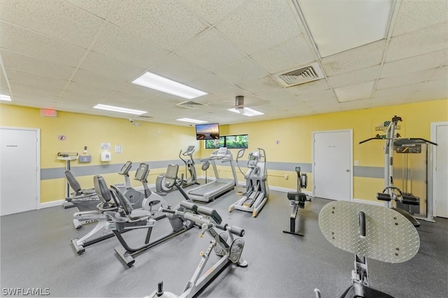 workout area featuring a paneled ceiling