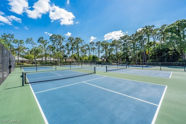 view of tennis court with basketball hoop