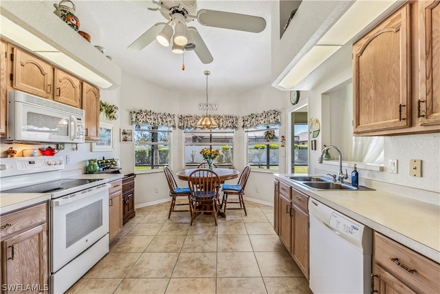 kitchen with decorative light fixtures, white appliances, ceiling fan, sink, and light tile floors