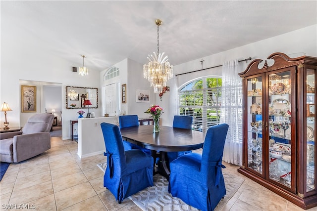 tiled dining area featuring vaulted ceiling and a chandelier