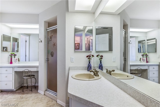 bathroom with a shower with shower door, vanity, and tile floors