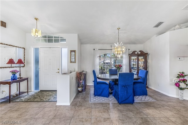 tiled dining area featuring a chandelier