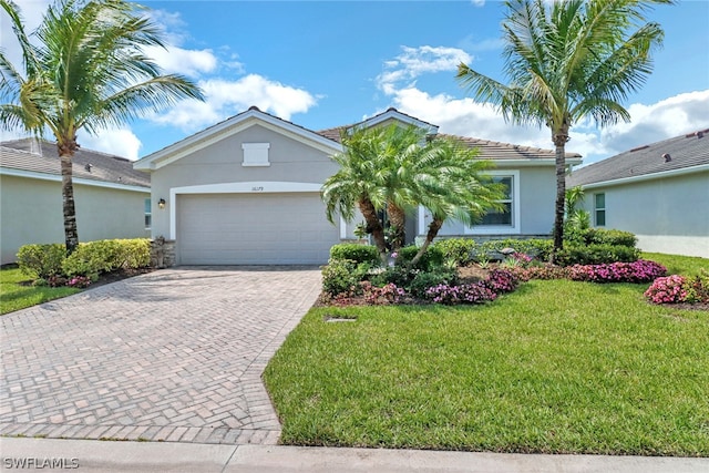 view of front of house with a garage and a front lawn