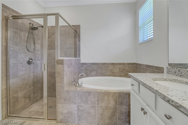 bathroom featuring vanity, crown molding, and shower with separate bathtub