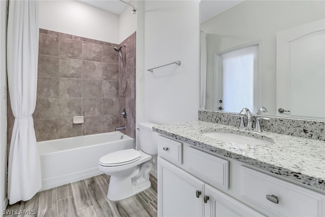 full bathroom with vanity with extensive cabinet space, shower / tub combo, toilet, and wood-type flooring