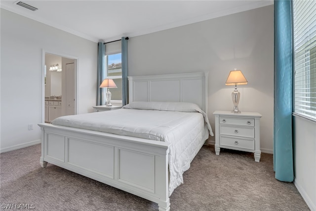 bedroom with crown molding, light carpet, ensuite bathroom, and multiple windows