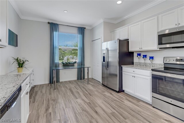 kitchen featuring light stone counters, stainless steel appliances, light wood-type flooring, and white cabinetry