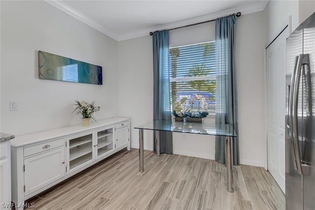 office space with ornamental molding and light hardwood / wood-style floors