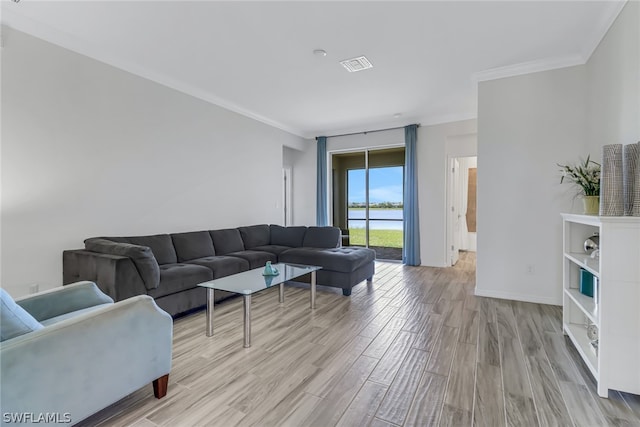 living room with crown molding and light wood-type flooring