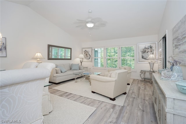 living room with light hardwood / wood-style floors, ceiling fan, and vaulted ceiling