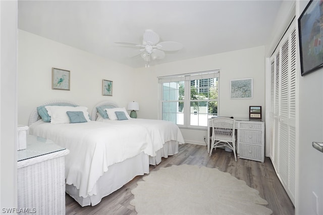 bedroom featuring a closet, ceiling fan, and dark hardwood / wood-style floors