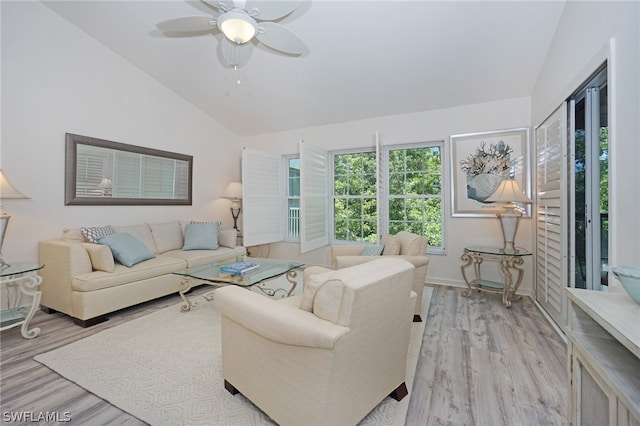 living room with lofted ceiling, ceiling fan, and light hardwood / wood-style floors