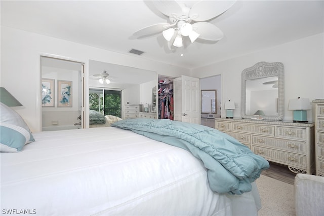 bedroom featuring a closet, a spacious closet, and ceiling fan