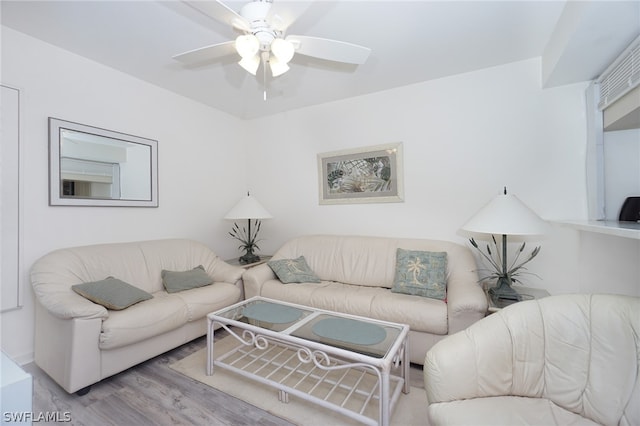 living room featuring ceiling fan and light hardwood / wood-style floors